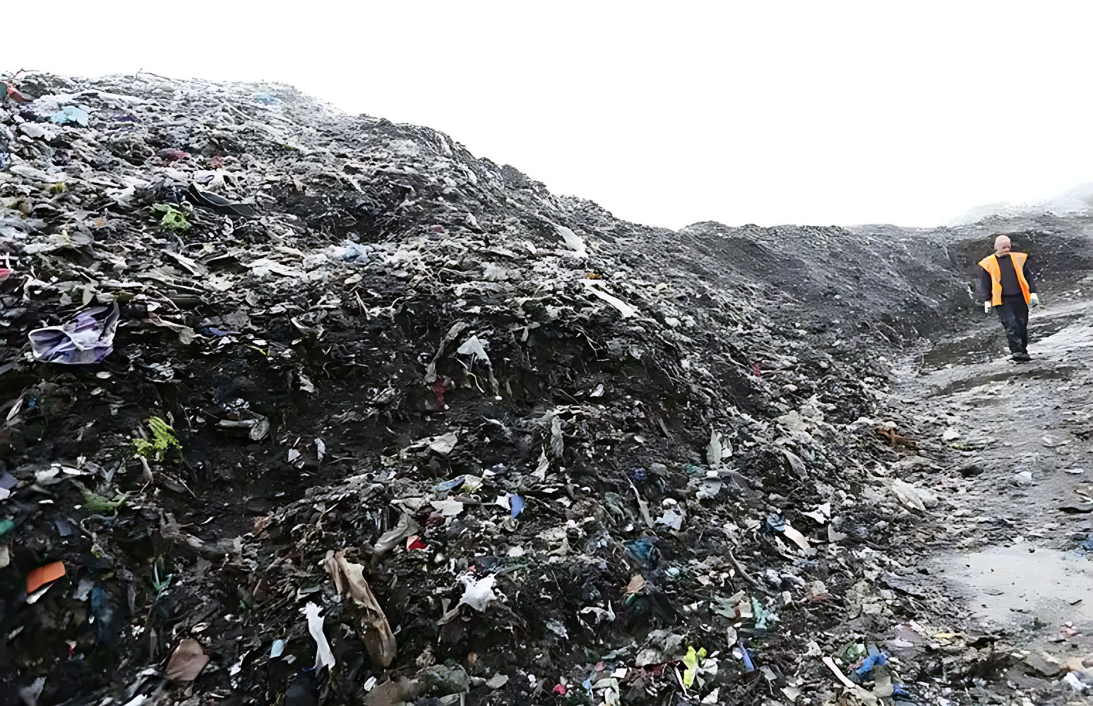 A 15 meter high garbage mountain near a village in 